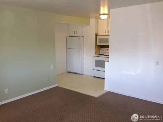 an empty room with a kitchen