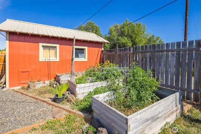 a view of a house with wooden fence
