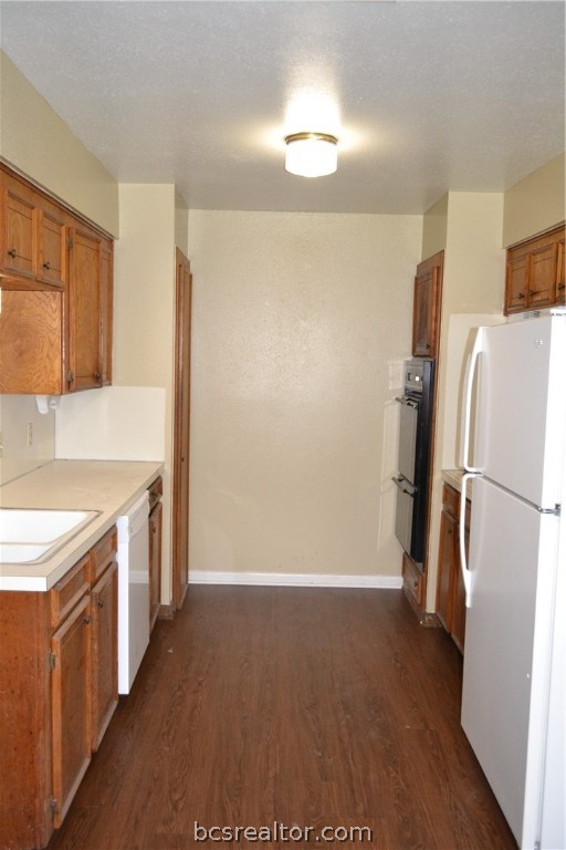 a kitchen with a refrigerator a stove a washer and dryer