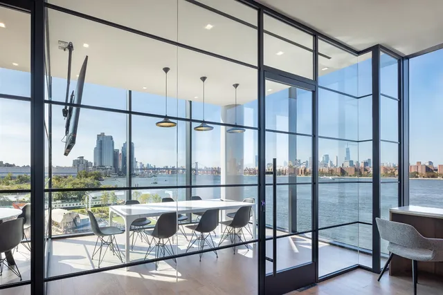 a dining room with furniture a chandelier and wooden floor