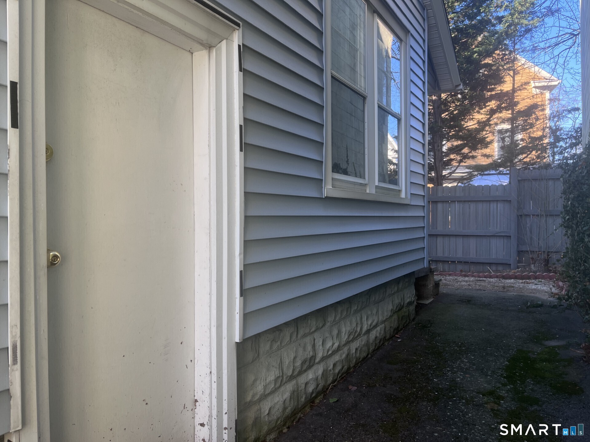 124 Thorpe Street Fairfield, CT 06824 - Photo 21 of 23 a back view of a house with a yard