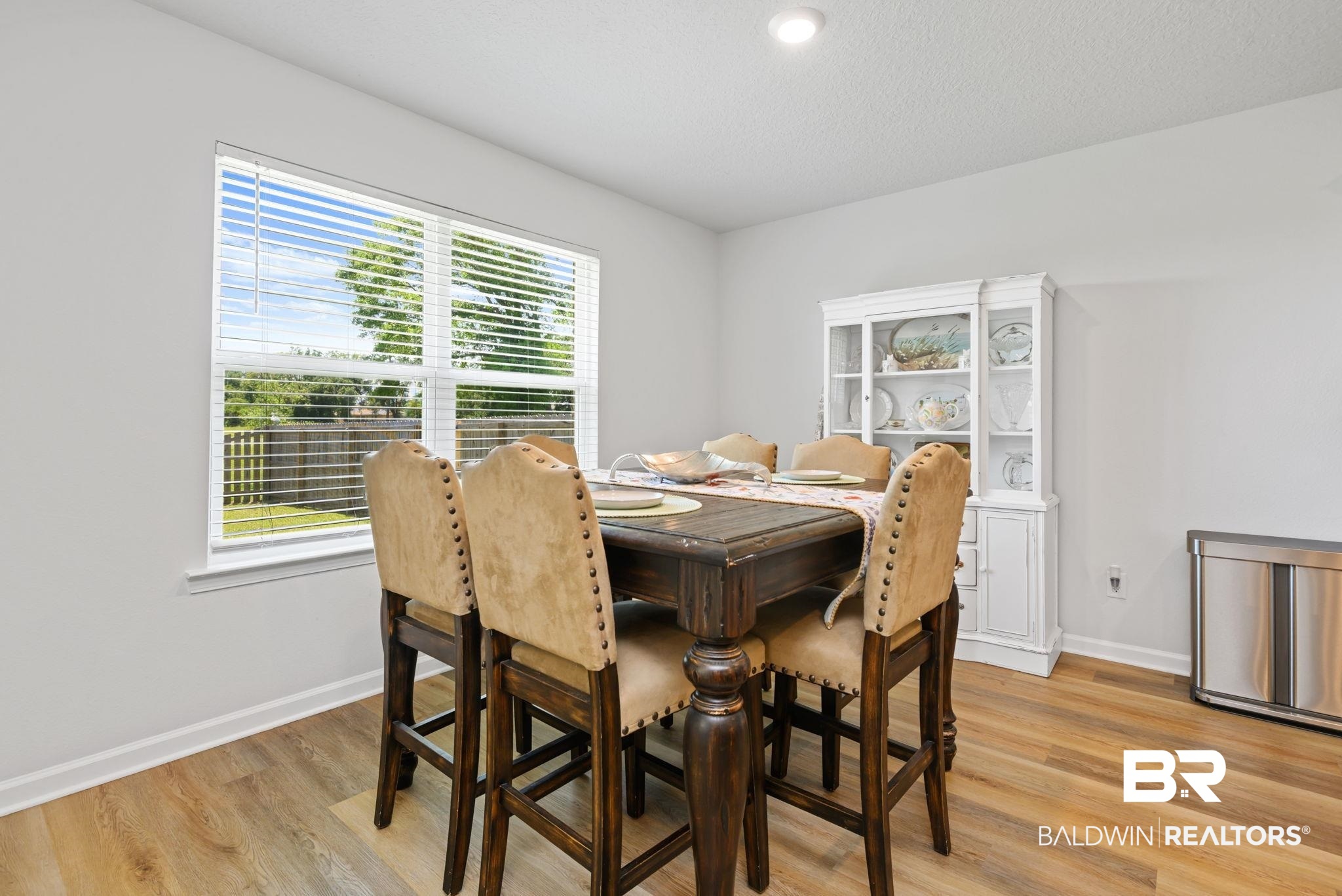 8021 Valor Rdg Way North Mobile, AL 36619 - Photo 26 of 34 Dining area featuring wood-finish flooring and a white built-in hutch