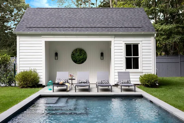 a view of a house with patio yard and swimming pool