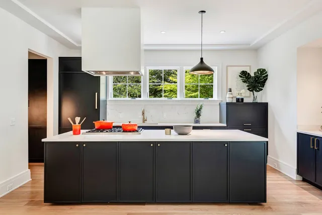 a room with a large window and chandelier