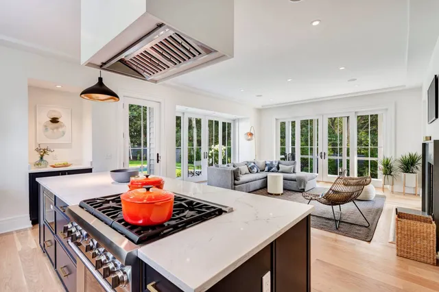 a living room with furniture and large windows