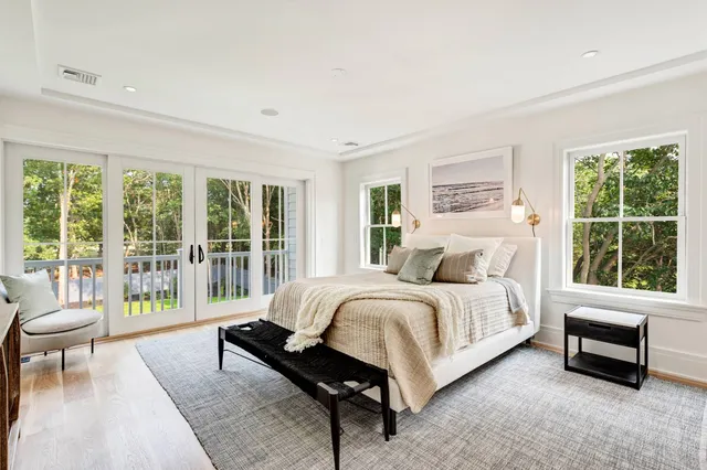 a spacious bedroom with a bed and a large window