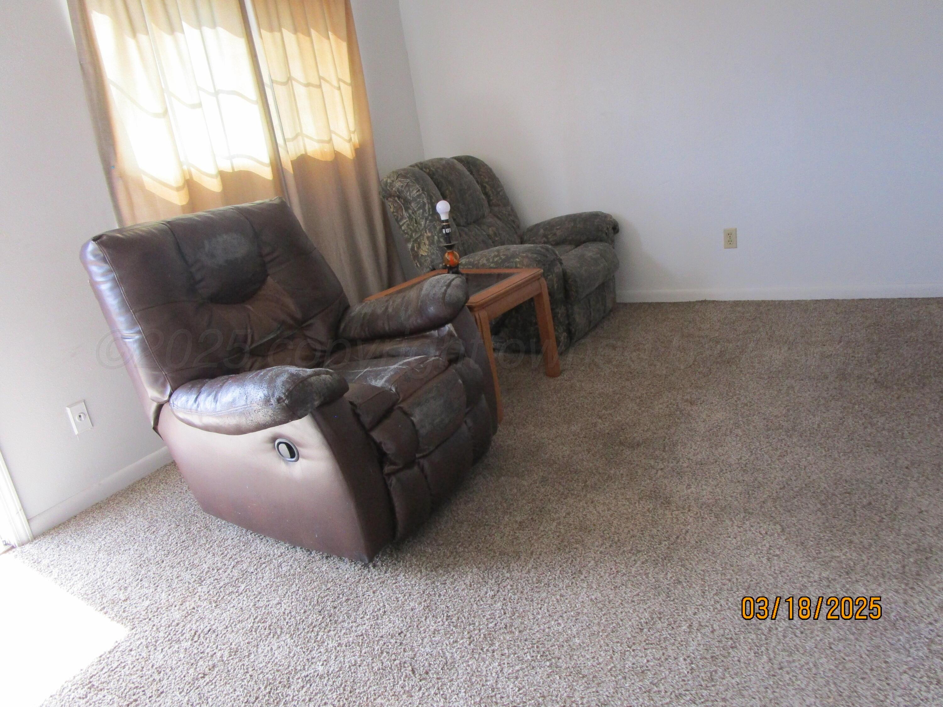 200 West 7th Street Borger, TX 79007 - Photo 2 of 8 a living room with furniture and a large window