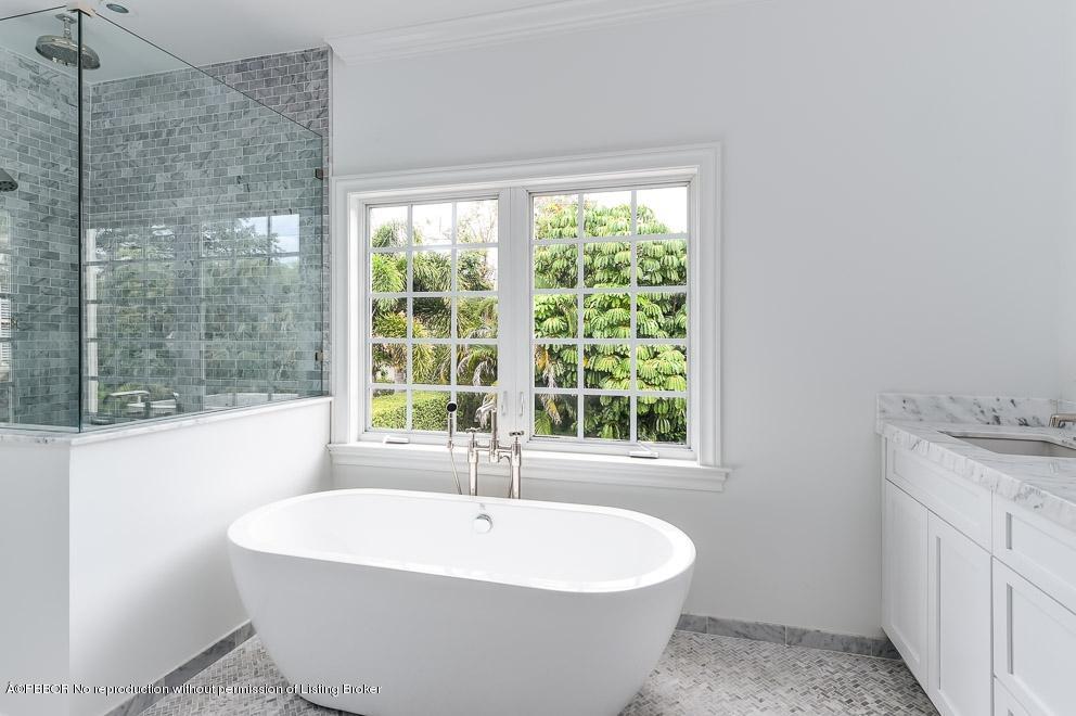 277 Cordova Road West Palm Beach, FL 33401 - Photo 12 of 18 a white bath tub sitting in a bathroom next to a window