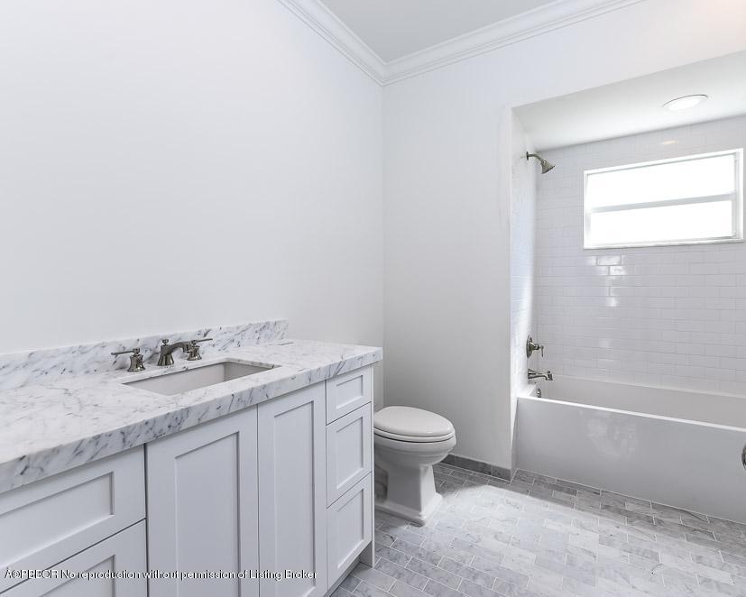277 Cordova Road West Palm Beach, FL 33401 - Photo 15 of 18 a bathroom with a granite countertop sink a toilet and bathtub