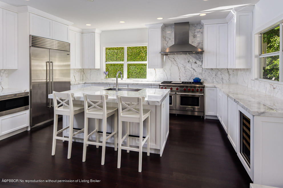 277 Cordova Road West Palm Beach, FL 33401 - Photo 6 of 18 a kitchen with stainless steel appliances kitchen island granite countertop a stove a sink and a refrigerator