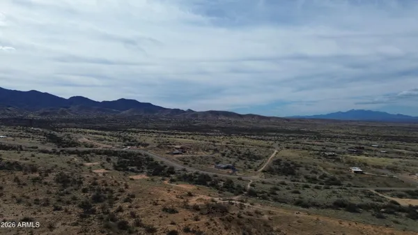 a view of a large mountain with mountains in the background