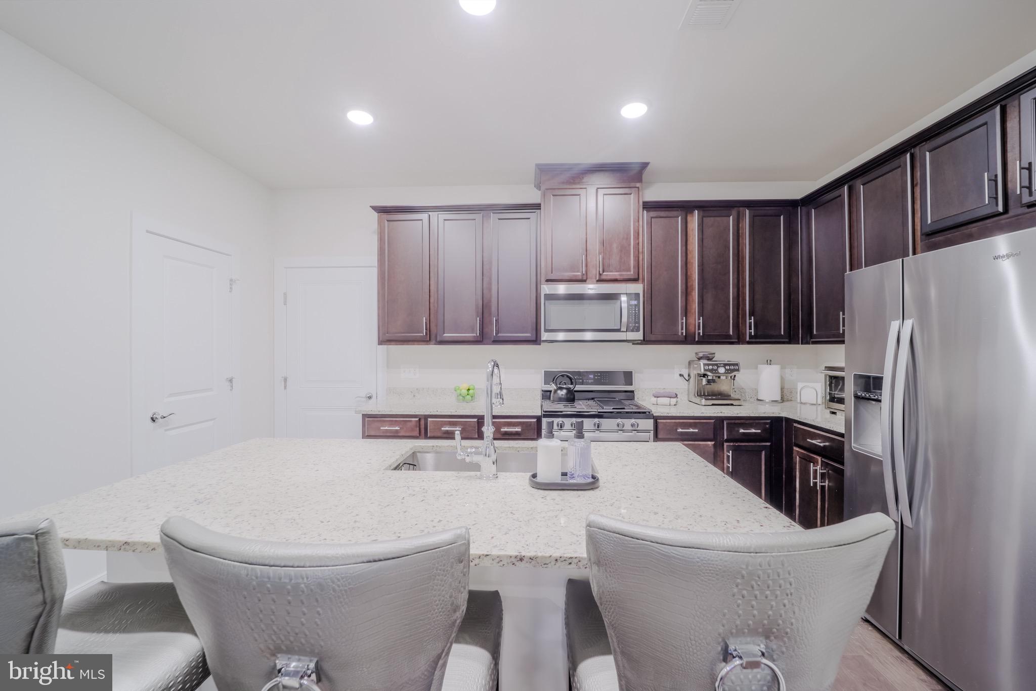 20355 Century Boulevard, Unit 177L Germantown, MD 20874 - Photo 12 of 69 a bathroom with a sink toilet and a mirror