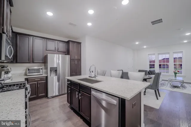 a view of a kitchen with fridge and rack