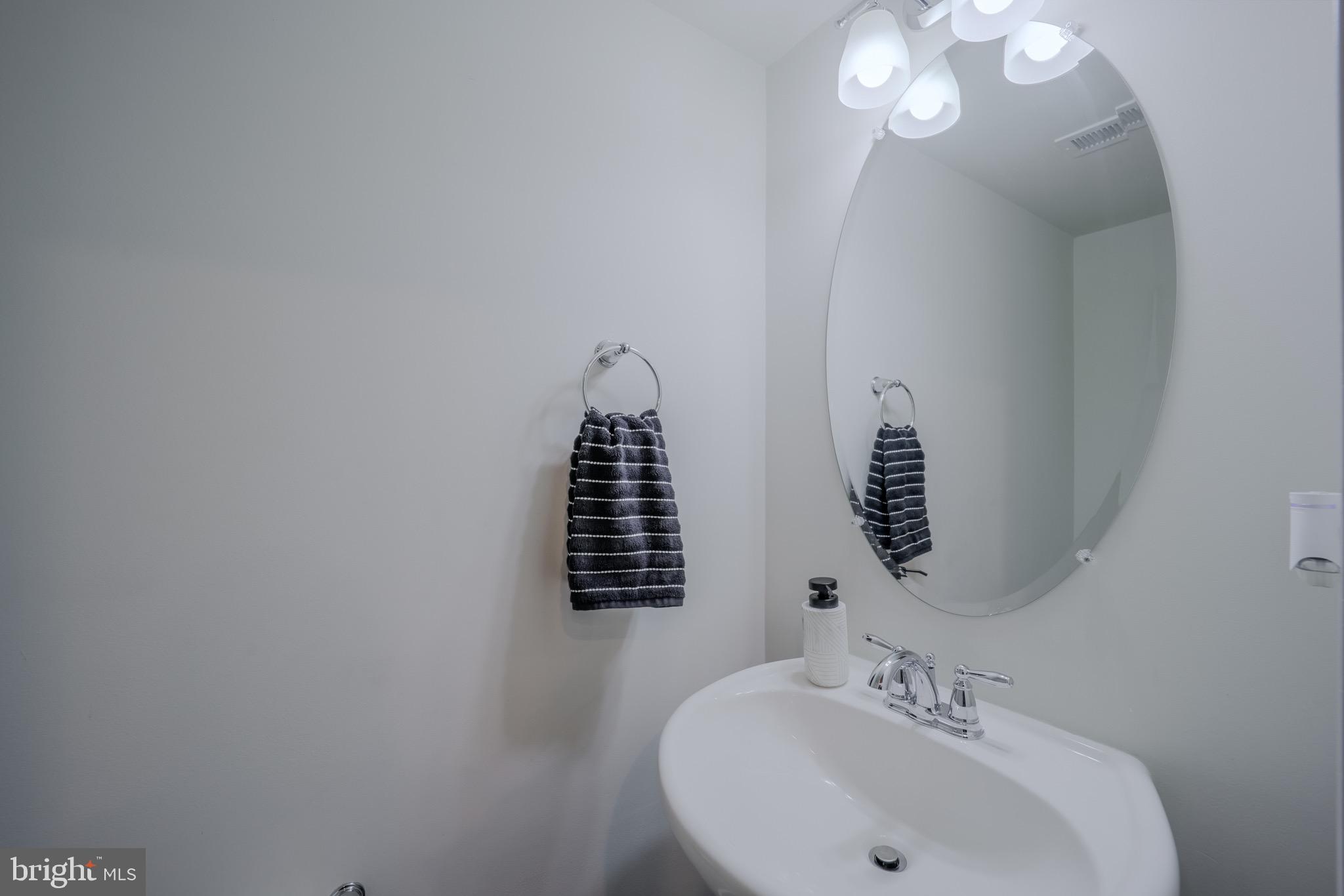 20355 Century Boulevard, Unit 177L Germantown, MD 20874 - Photo 18 of 69 a bathroom with a sink and a mirror