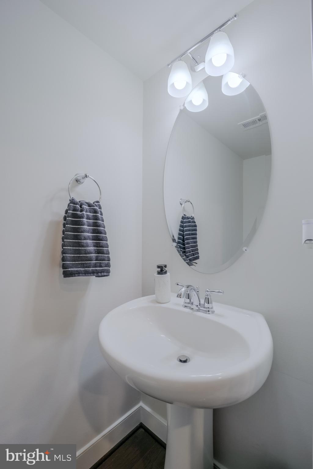20355 Century Boulevard, Unit 177L Germantown, MD 20874 - Photo 19 of 69 a bathroom with a sink a mirror and a window