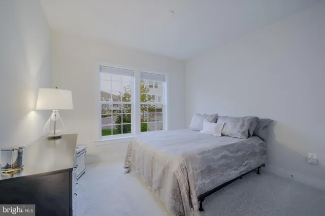 a bedroom with a bed and a book shelf