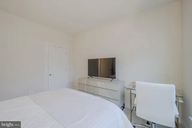 a view of an apartment with a swimming pool and a chairs