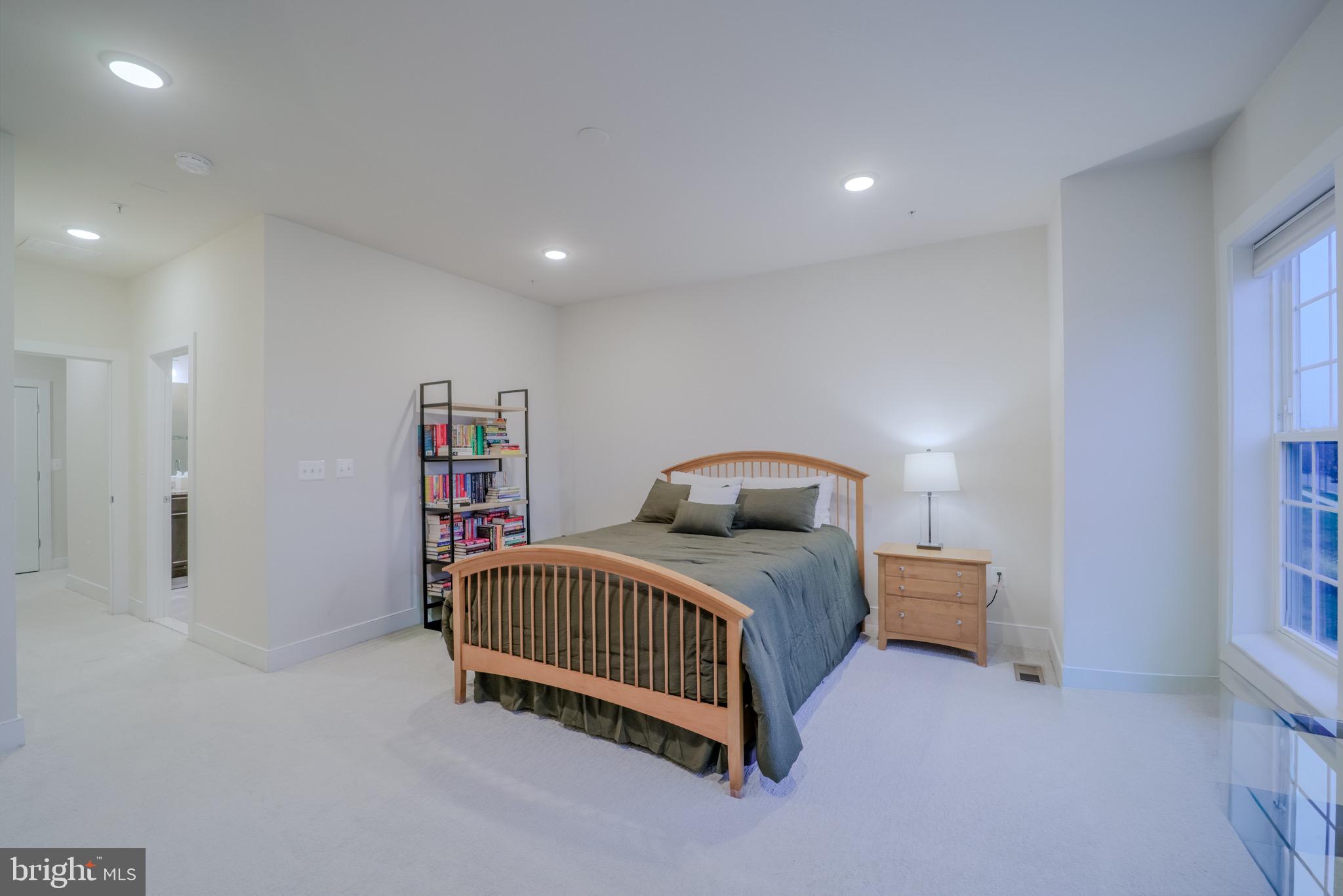 20355 Century Boulevard, Unit 177L Germantown, MD 20874 - Photo 35 of 69 a bedroom with a bed and a book shelf