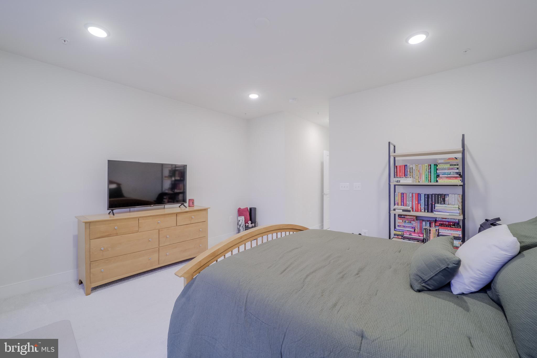 20355 Century Boulevard, Unit 177L Germantown, MD 20874 - Photo 37 of 69 a bedroom with a bed and flat screen tv