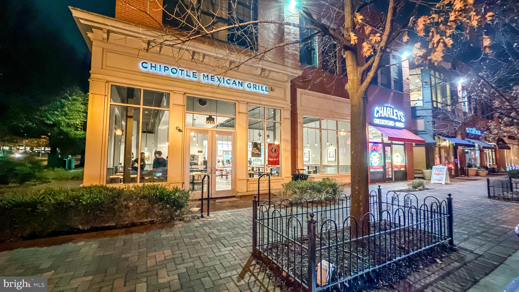 20355 Century Boulevard, Unit 177L Germantown, MD 20874 - Photo 48 of 69 a view of a brick house with large windows and a table and chairs