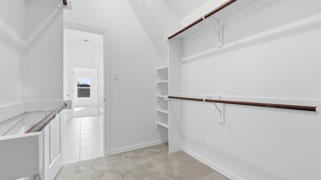 2529 Rivers W Road Anna, TX 75409 - Photo 35 of 40 Expansive closet space featuring plush carpet flooring, multiple shelving units, and two levels of hanging rods