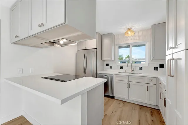 a kitchen with a stove and white cabinets