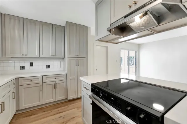 a kitchen with a stove and a refrigerator