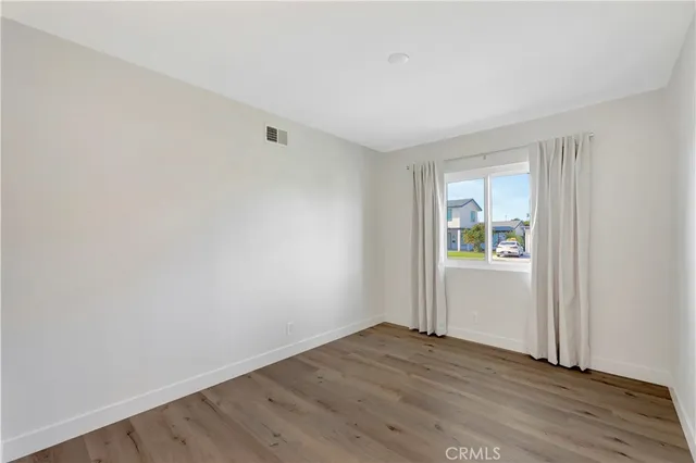 a view of an empty room and wooden floor