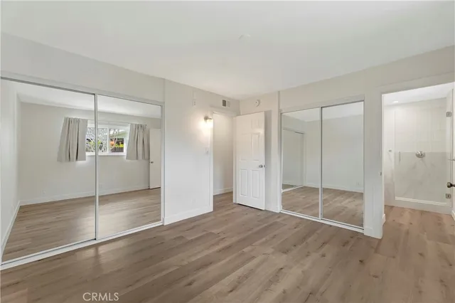 a bathroom with a sink a toilet a mirror and shower