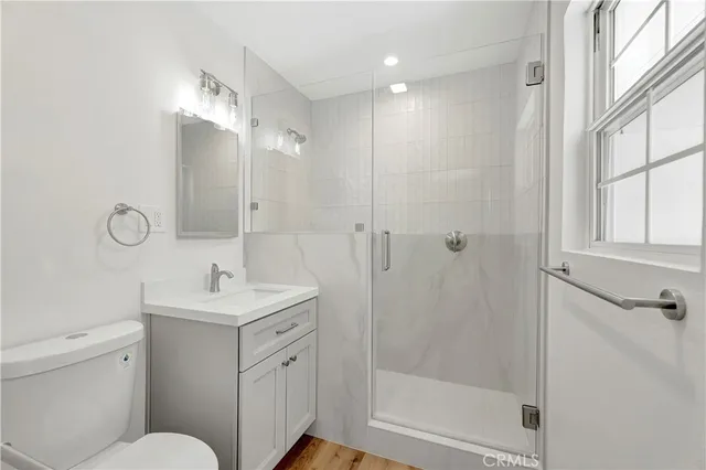 a bathroom with a toilet sink shower and mirror