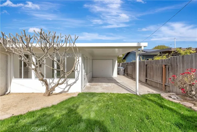 a house view with a sitting space and garden