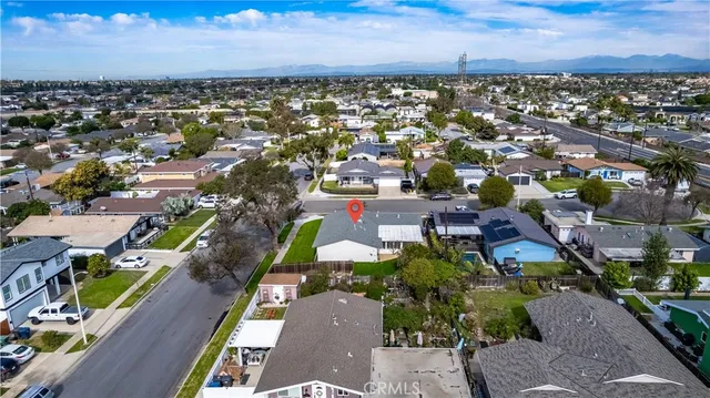 an aerial view of a house with a garden and lake view