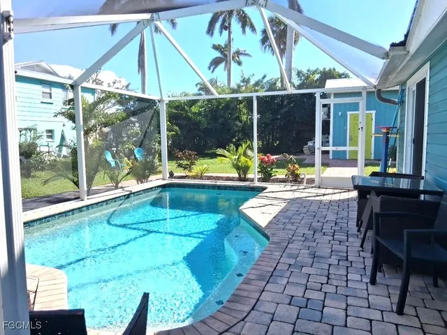 a view of a patio with table and chairs under an umbrella