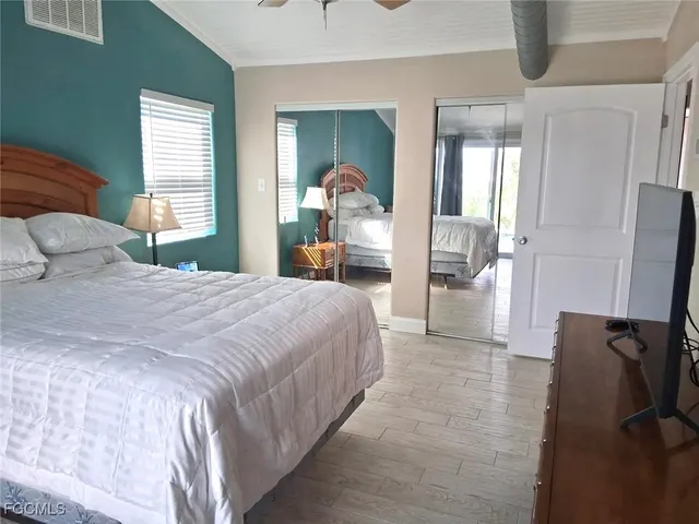 a bedroom with a bed and large mirror