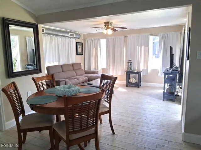 a dining room with furniture and window