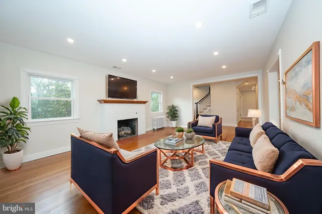 a view of empty room with wooden floor and fireplace
