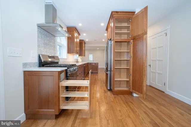 a kitchen view with wooden floor and cabinets