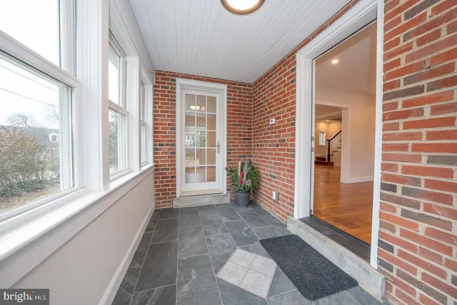 a view of empty room with wooden floor and fireplace