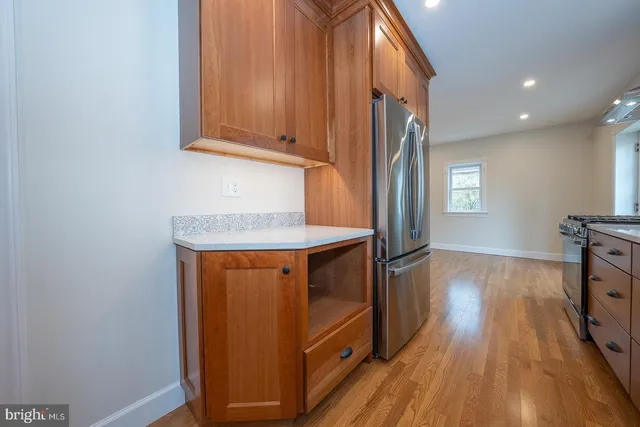 a kitchen with stainless steel appliances granite countertop a refrigerator and a stove top oven