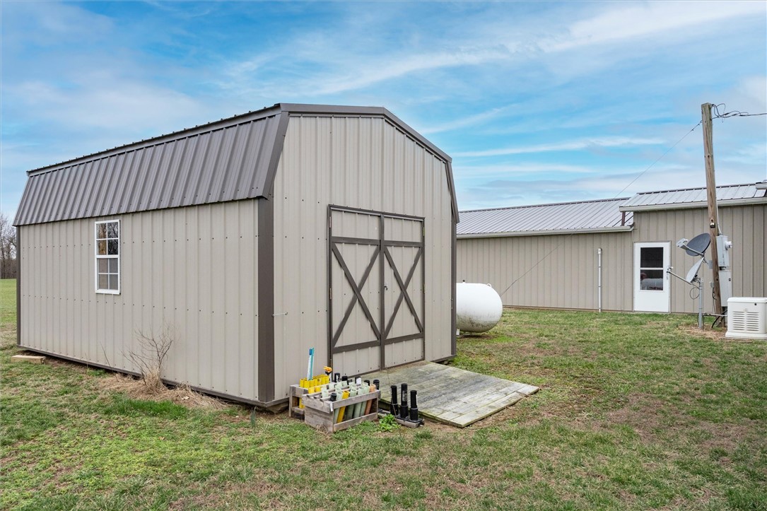 1926 Fairview Road Peebles, OH 45660 - Photo 17 of 44 This spacious barn offers practical storage and workspace, complementing a larger nearby structure.