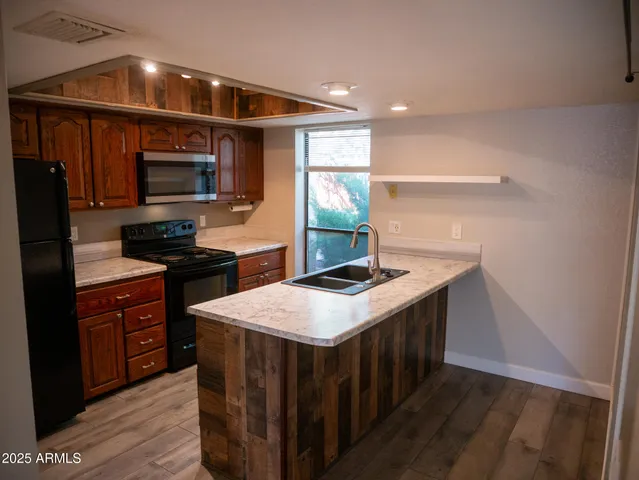 a kitchen that has a sink and a stove in it
