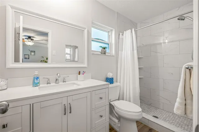 a bathroom with a sink toilet and shower