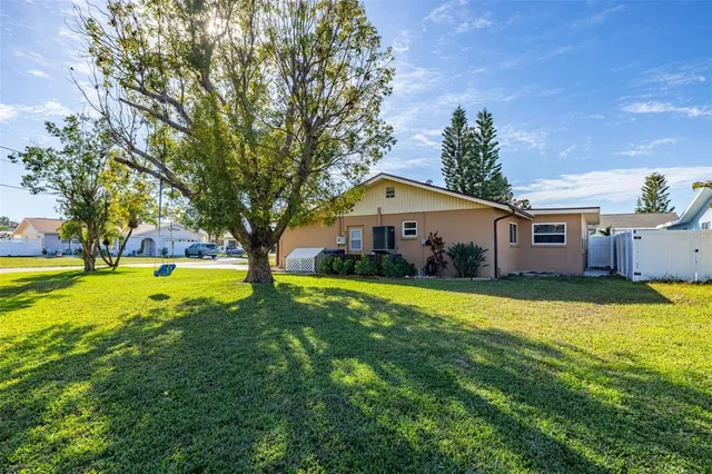 a front view of house with swimming pool and green space