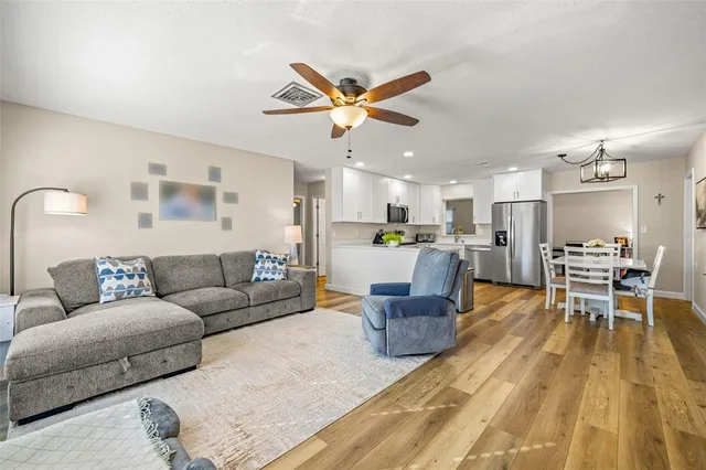 a living room with furniture and kitchen view