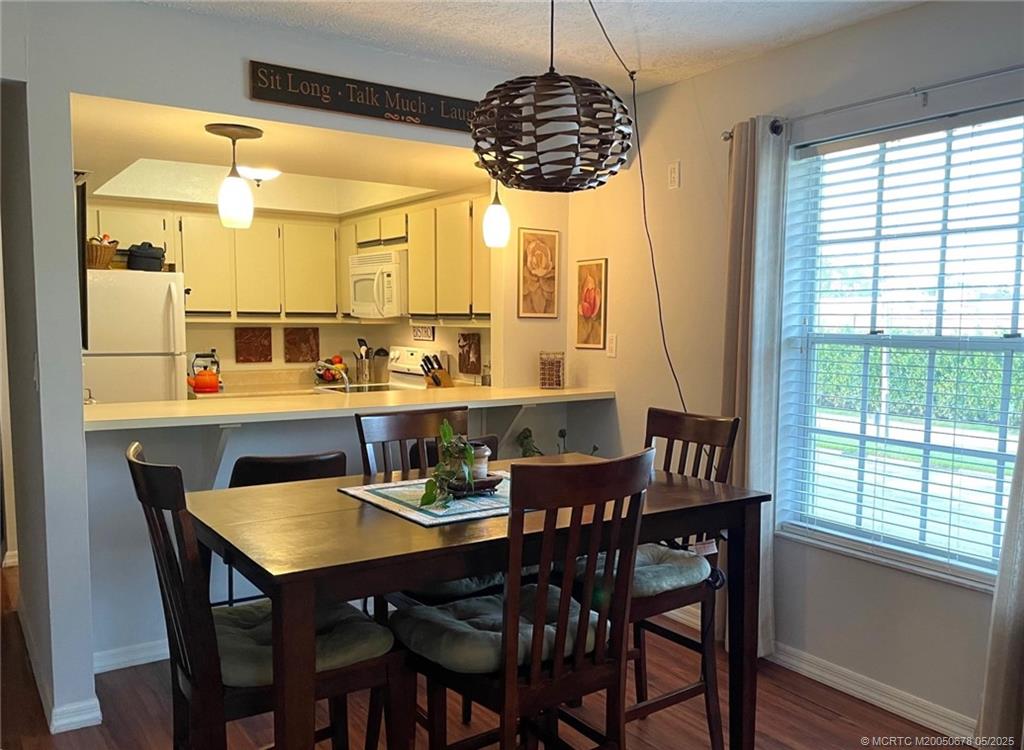 801 Southeast Central Parkway, Unit 8019 Stuart, FL 34994 - Photo 17 of 41 a dining room with furniture and window