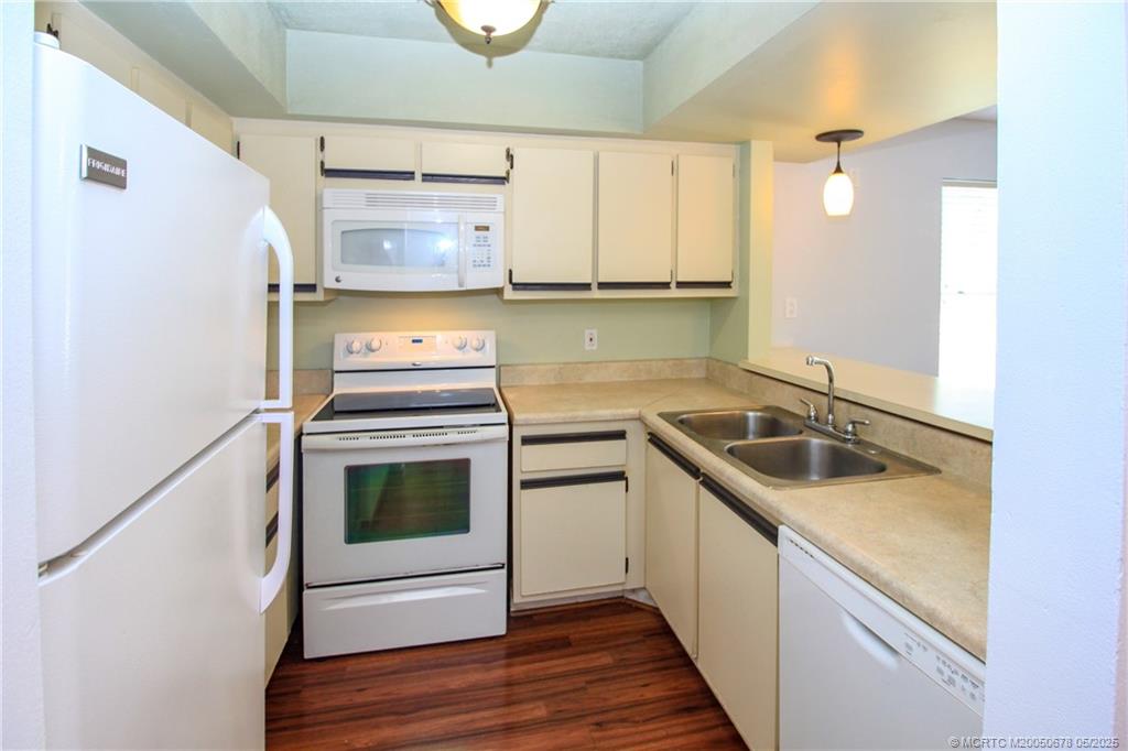 801 Southeast Central Parkway, Unit 8019 Stuart, FL 34994 - Photo 20 of 41 a kitchen with a sink stove and cabinets