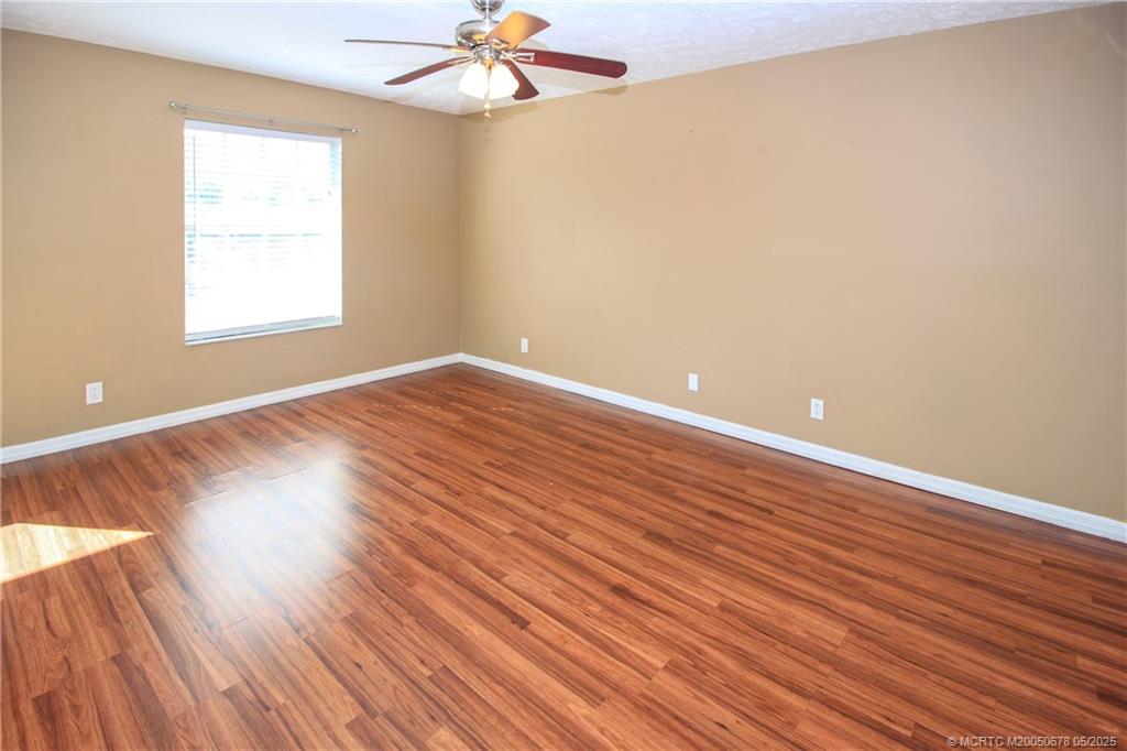 801 Southeast Central Parkway, Unit 8019 Stuart, FL 34994 - Photo 22 of 41 wooden floor in an empty room with a window