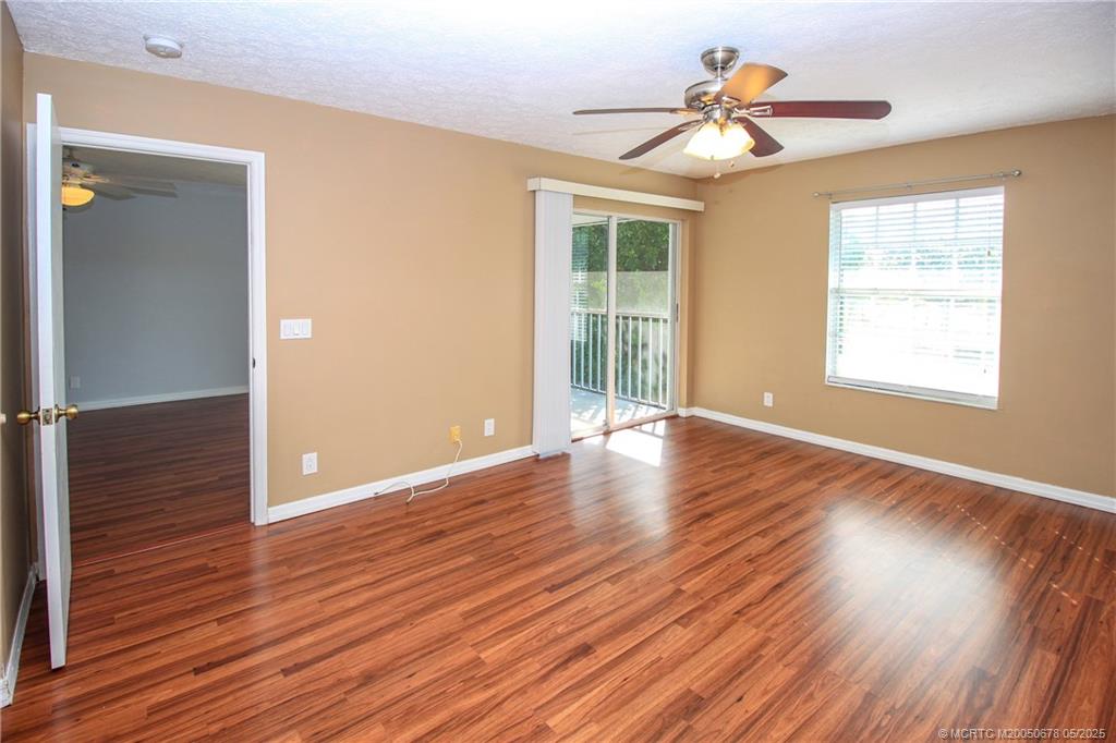 801 Southeast Central Parkway, Unit 8019 Stuart, FL 34994 - Photo 23 of 41 a view of an empty room with wooden floor and a window