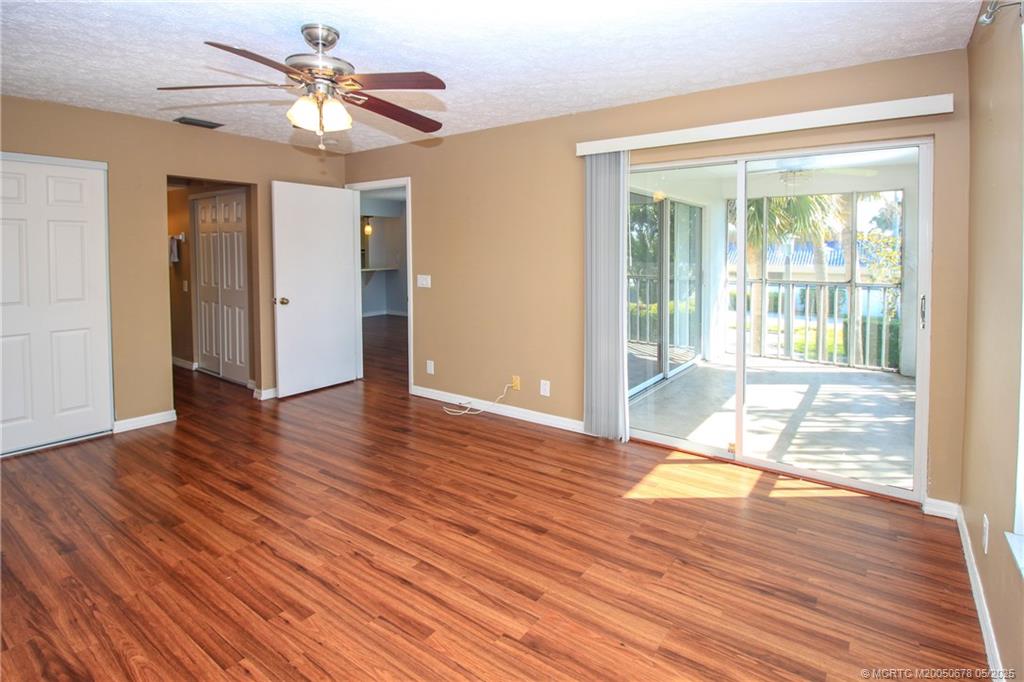 801 Southeast Central Parkway, Unit 8019 Stuart, FL 34994 - Photo 24 of 41 a view of an empty room with wooden floor and a window
