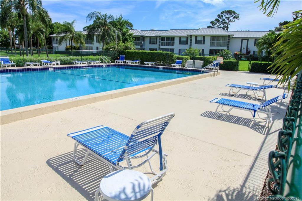 801 Southeast Central Parkway, Unit 8019 Stuart, FL 34994 - Photo 41 of 41 a view of a patio with chairs and a table with swimming pool